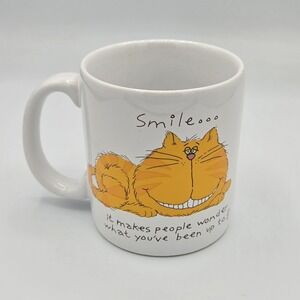 Vtg Smile... It Makes People Wonder What You've Been Up To! Orange tabby cat mug